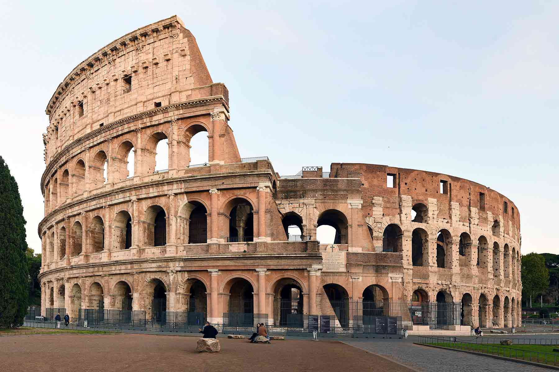 The iconic Colosseum in Rome against clear morning sky
