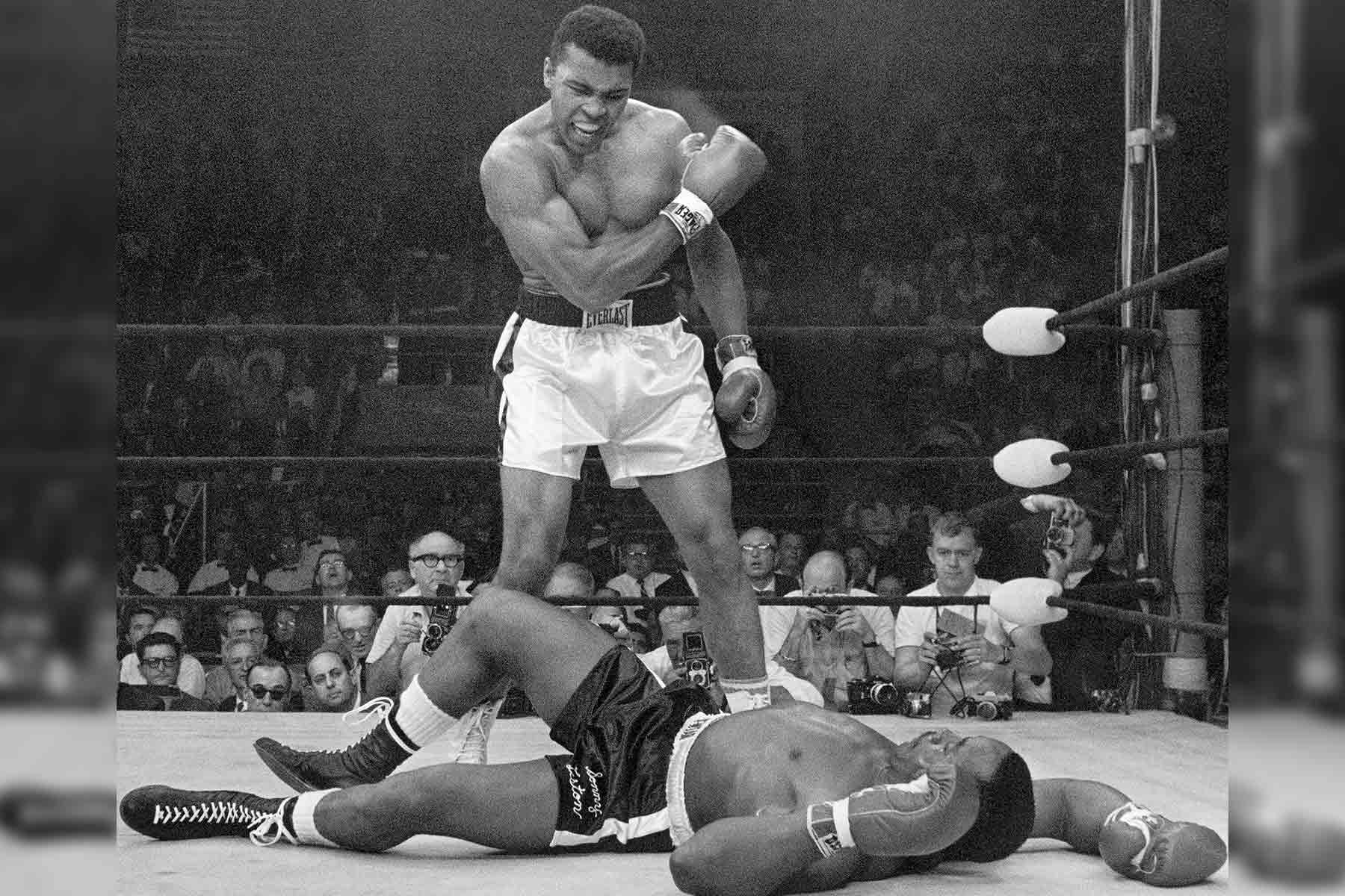 Muhammad Ali stands over Sonny Liston after knocking him out with the controversial "phantom punch" (1965)