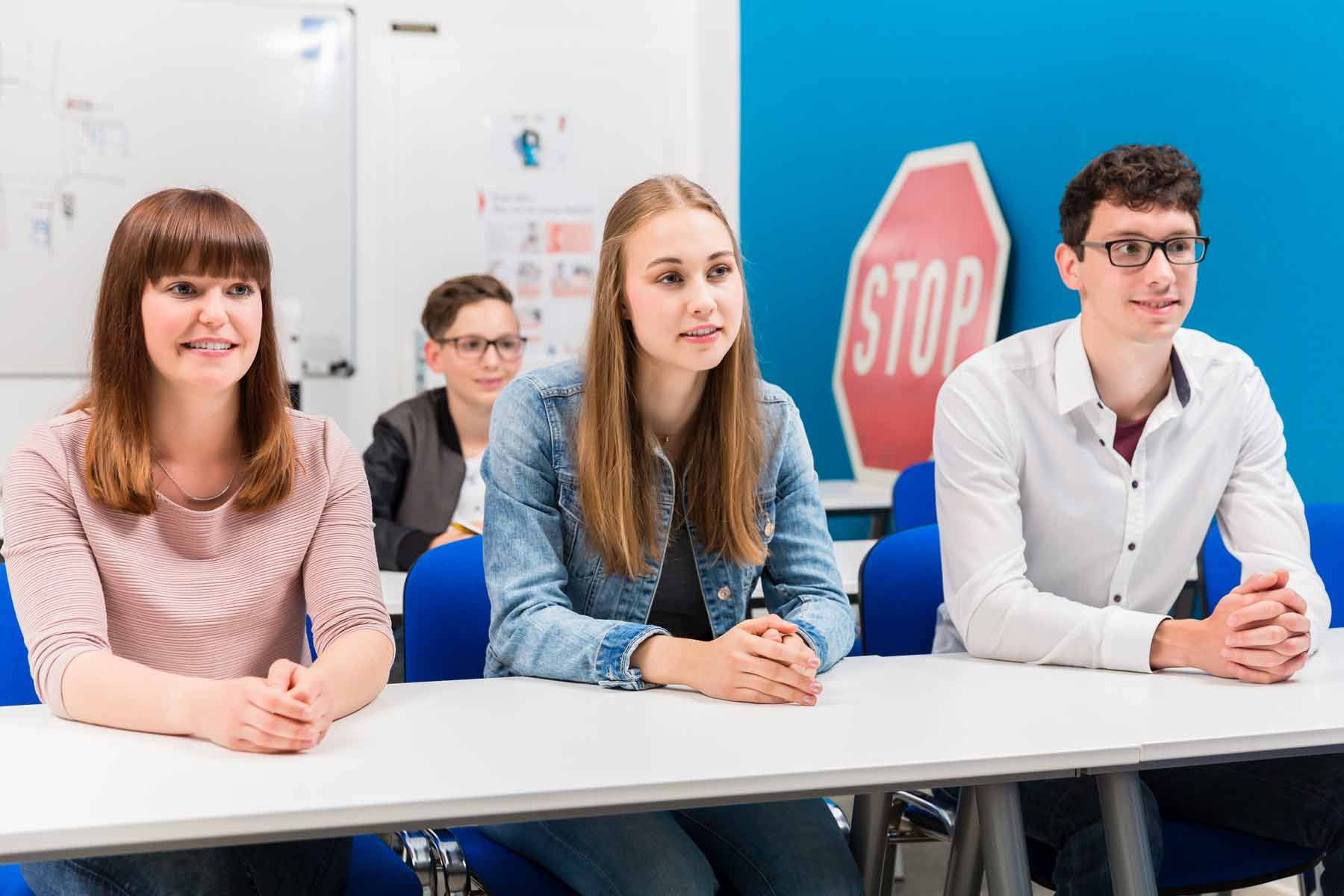 Students listening to the instructor in a driving school class