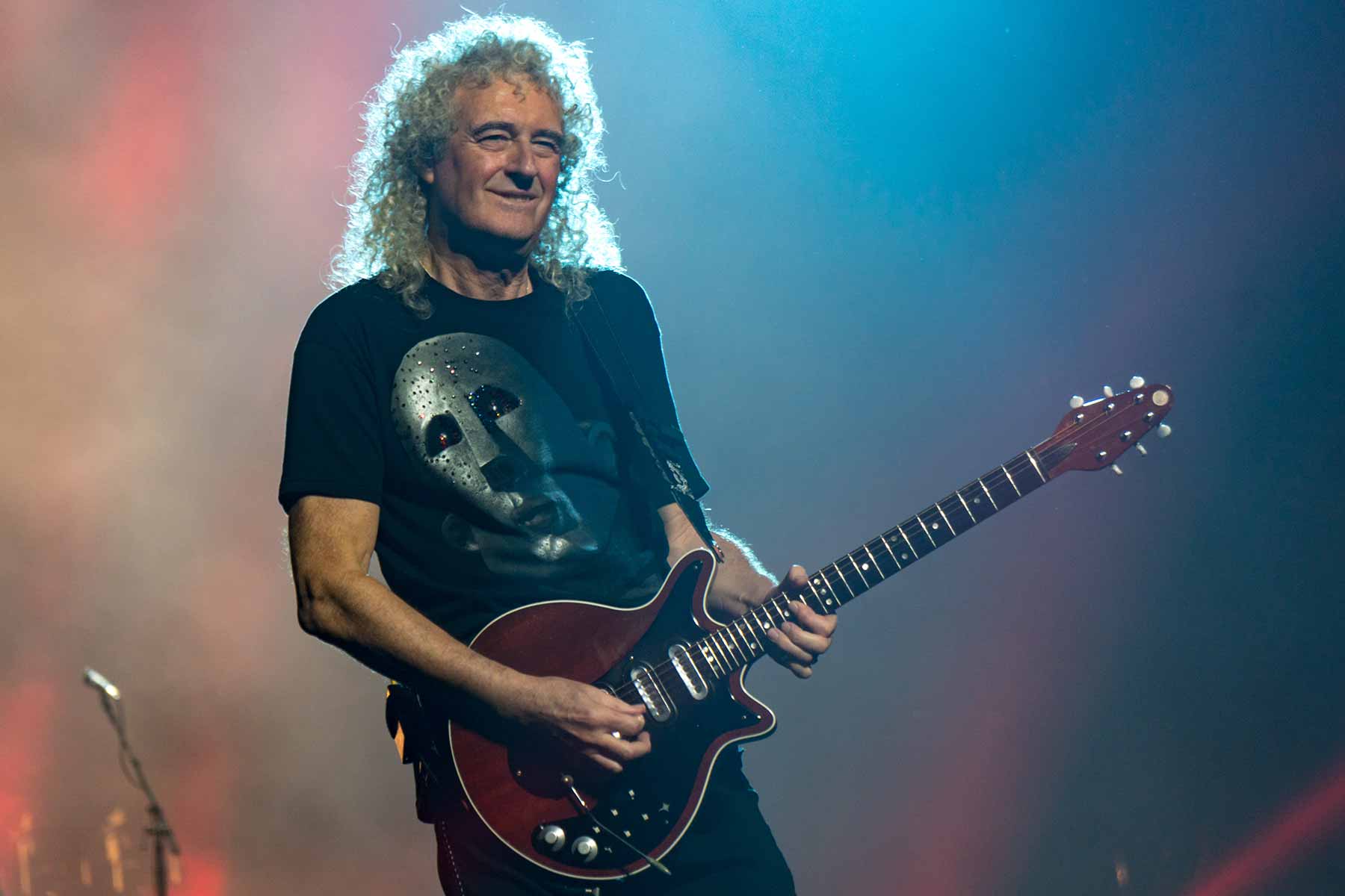 Queen's legendary guitarist Brian May playing his signature red electric guitar (Photo credit: Wikimedia Commons/Raph_PH)